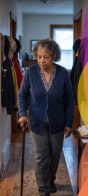 Woman with Cane walking in hallway